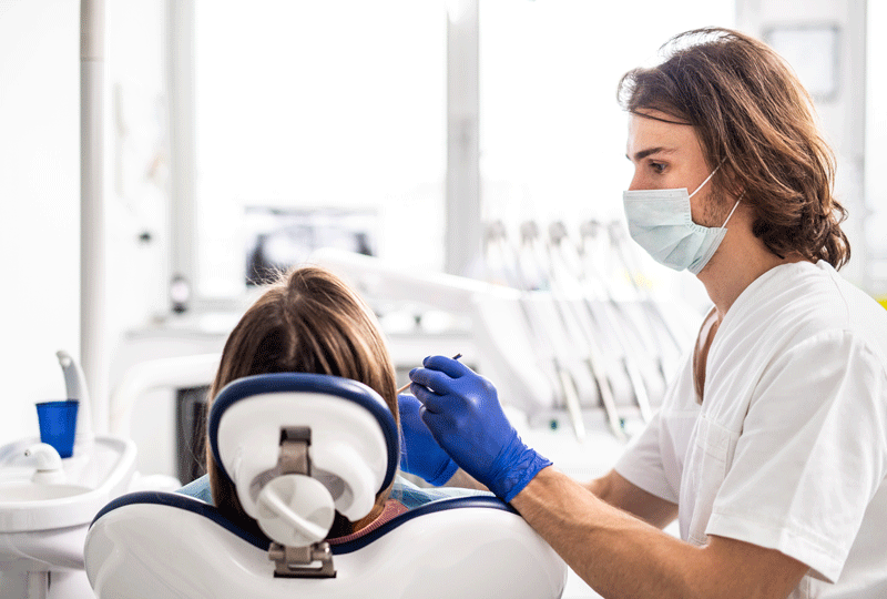 A dental check-up of patient in dentist surgery.